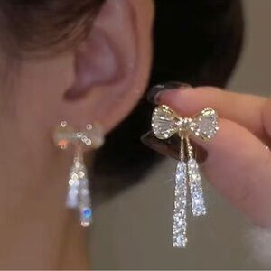 Crystal Bow earrings with 2 crystal dangles. 1.2” long. NIP.  Pop of shine